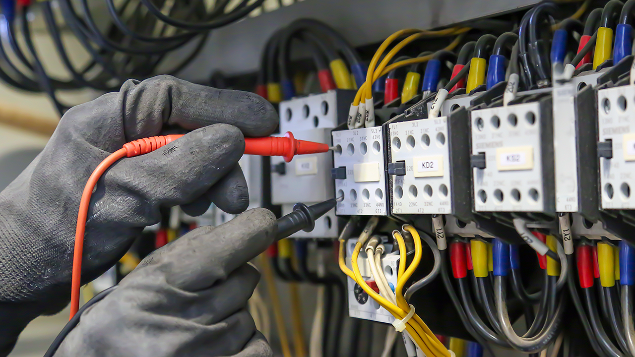 electrician servicing panel