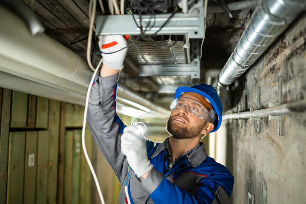 male technician connecting ceiling cables
